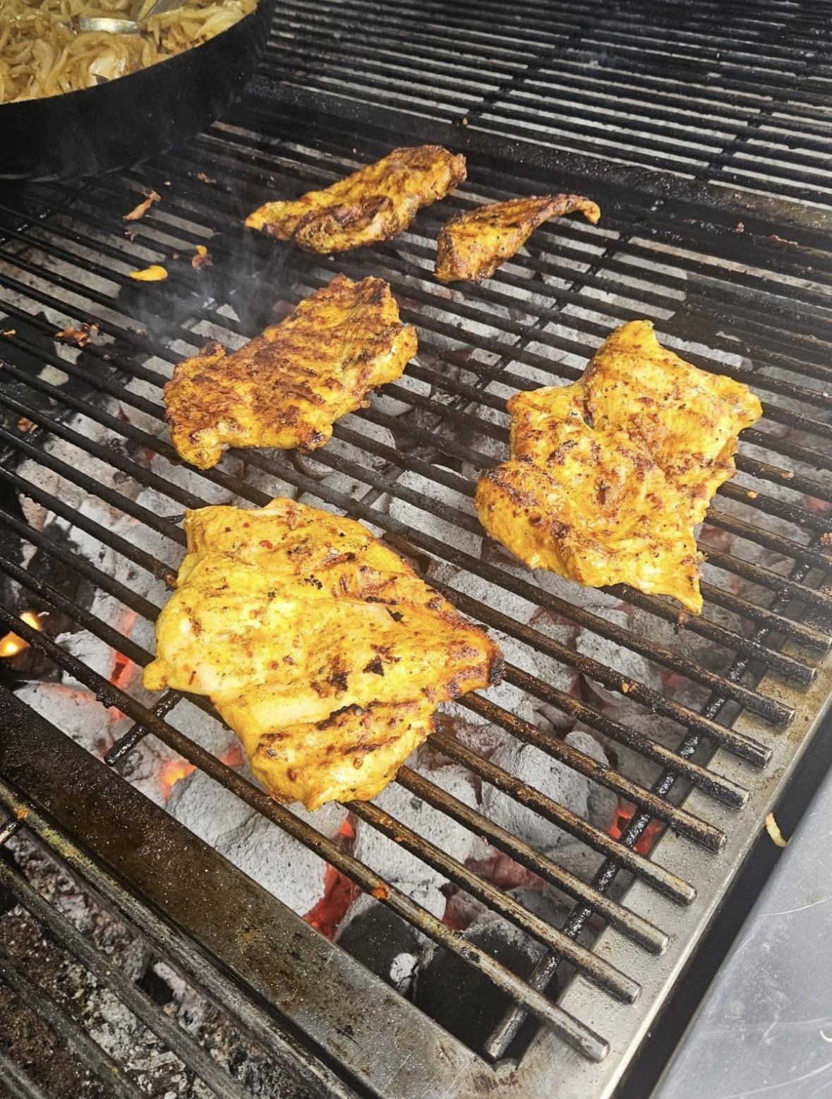 Marinated chicken thighs on the BBQ grill