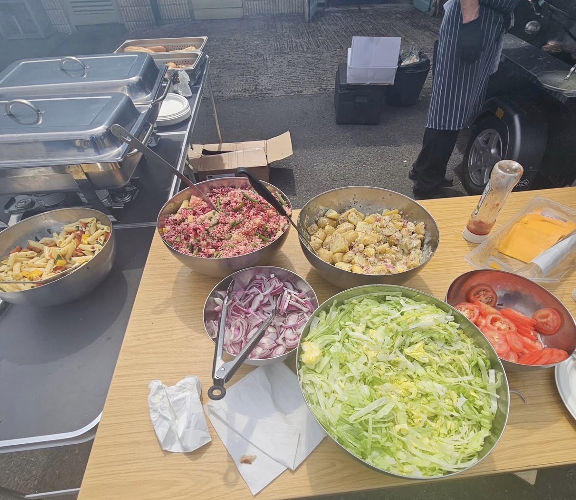 Fresh salads, cous cous and pasta on a buffet table