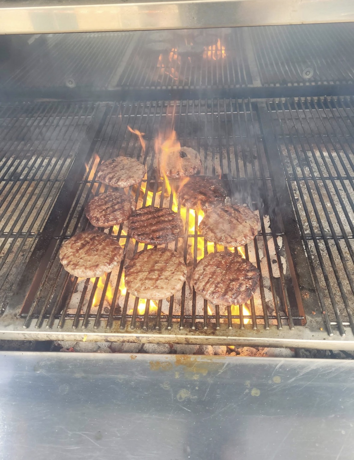Burgers grilling over open flame